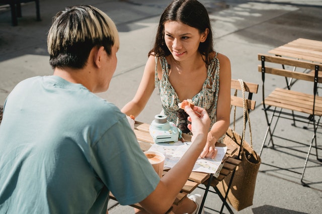 boyfriend and girlfriend sitting outside