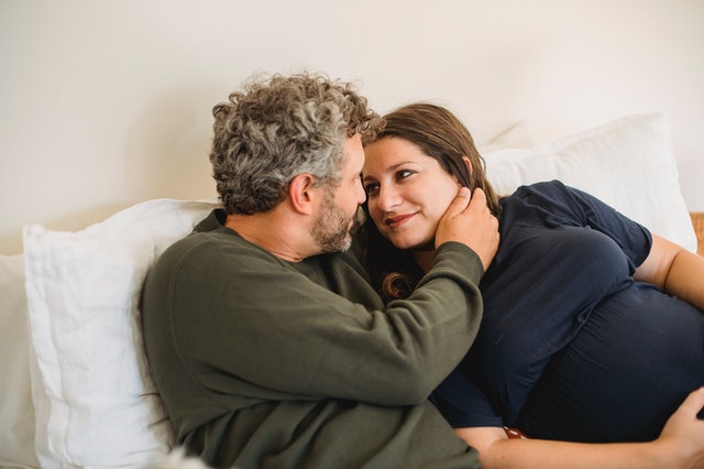 husband and wife talking in bed