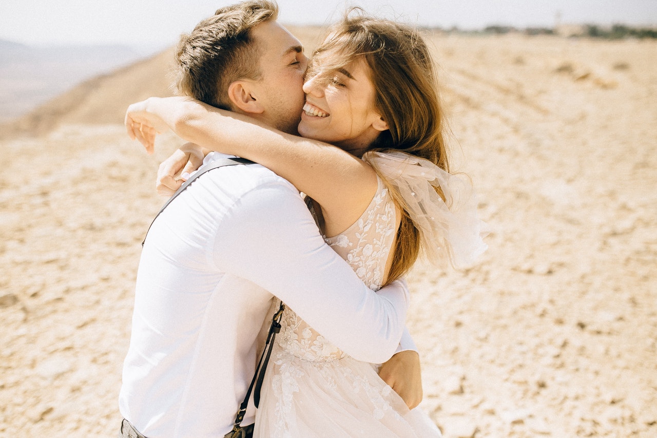 young couple kissing in the sand
