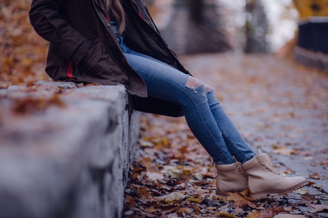 single girl sitting on the curb after break-up