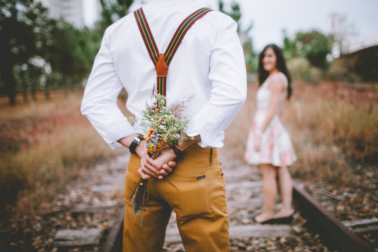 man giving woman flowers