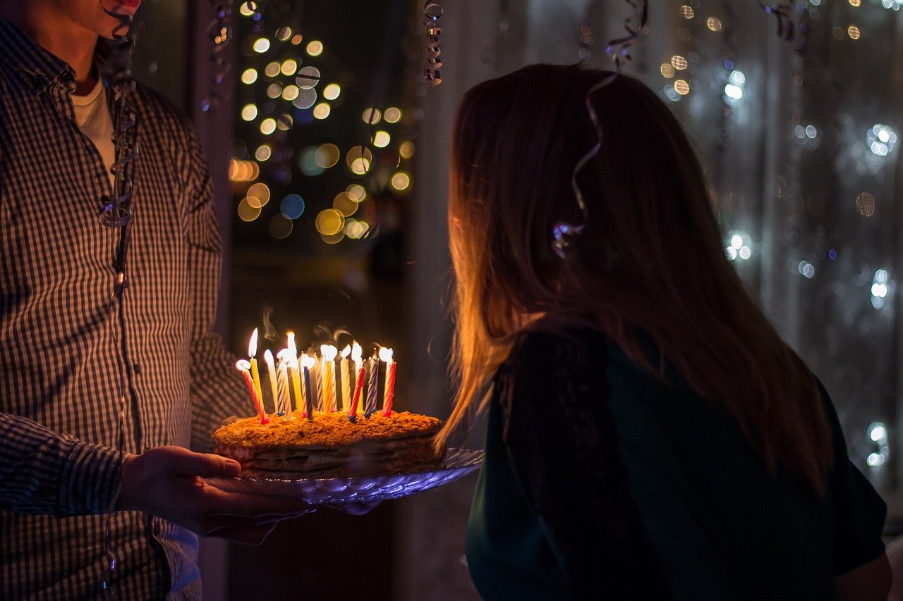 girlfriend giving her boyfriend a birthday cake