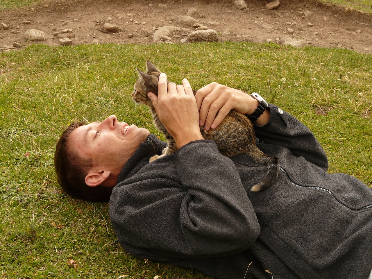 man holding cat outdoors