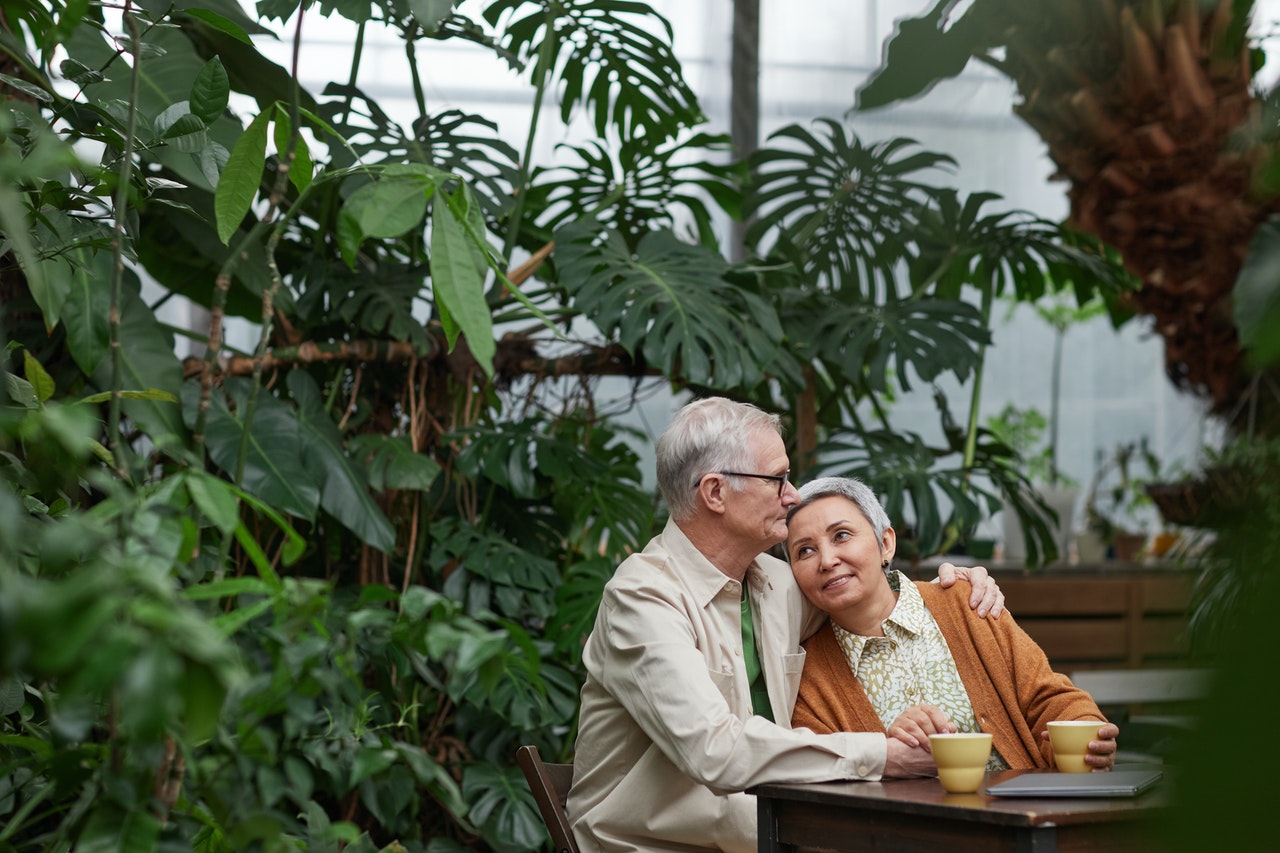 older couple smiling and drinking coffee older couple smiling and drinking coffee