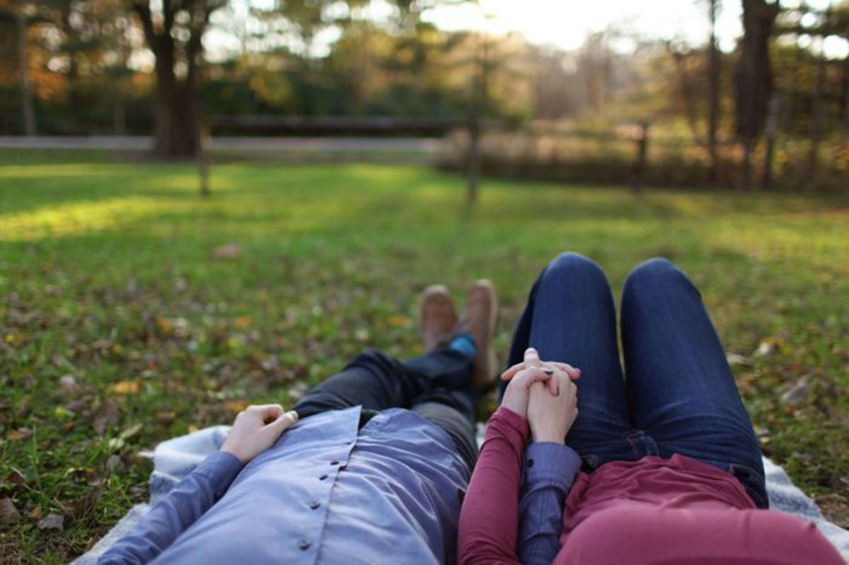 couple laying in the grass