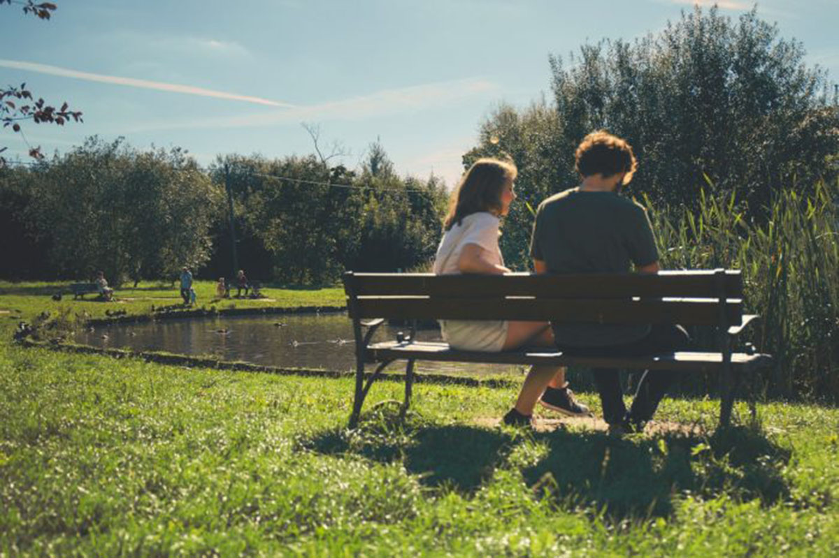 couple talking on park bench